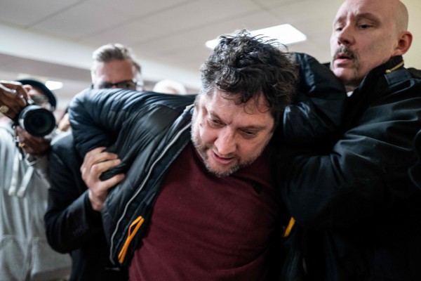 Anthony Kazmierczak is subdued after an attack on congresswoman Ilhan Omar during a town hall meeting in Minneapolis, Minnesota, on Tuesday. Photo: AFP