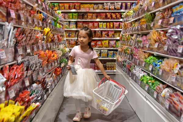 A girl selecting snacks in a shop in Mengzi city in southwestern China’s Yunnan province on October 15. Photo: Xinhua
