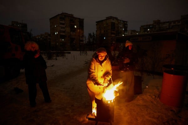 A resident warms up next to fire during a blackout in Kyiv, Ukraine, on Monday. Photo: Reuters A resident warms up next to fire during a blackout in Kyiv, Ukraine, on Monday. Photo: Reuters