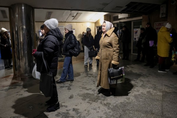 People in Kyiv stand at an entrance to a metro station while trains stopped running due to a blackout on Saturday. Photo: Reuters