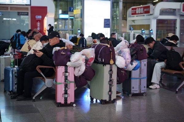 Travellers wait with their luggage at Tianjin Railway Station as people begin returning home ahead of the Spring Festival in Tianjin, China, on February 7. Photo: AP Travellers wait with their luggage at Tianjin Railway Station as people begin returning home ahead of the Spring Festival in Tianjin, China, on February 7. Photo: AP