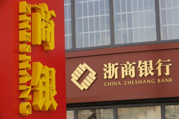 A signboard of China Zheshang Bank is seen at its branch in Beijing on March 14, 2016. Regulators have now tightened oversight of the bank. Photo: Reuters A signboard of China Zheshang Bank is seen at its branch in Beijing on March 14, 2016. Regulators have now tightened oversight of the bank. Photo: Reuters