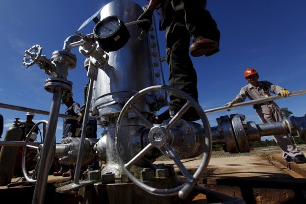 A Pertamina worker climbs on a gauge at a crude oil well on Bunyu island in Indonesia’s East Kalimantan province. Photo: Reuters A Pertamina worker climbs on a gauge at a crude oil well on Bunyu island in Indonesia’s East Kalimantan province. Photo: Reuters