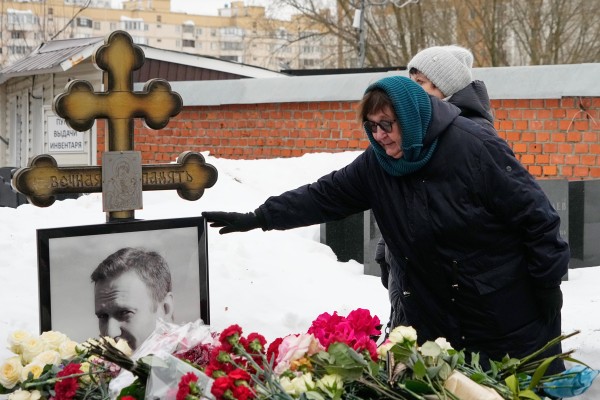 Lyudmila Navalnaya touches the portrait of her son, Alexei Navalny, at his grave in Borisovskoye Cemetery, Moscow, on Monday. Photo: AP