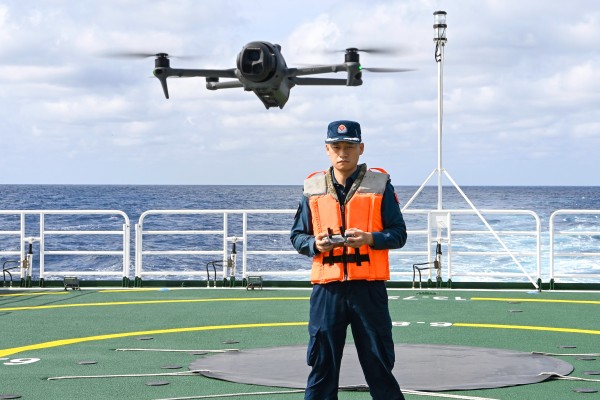 Qiu Canhui operates a drone aboard the Chinese coastguard vessel Wanshan near Scarborough Shoal in the South China Sea on February 11. Photo: Xinhua