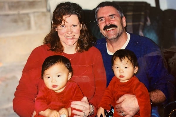 Phoebe McChesney, left, with her twin sister and parents in the US, after their adoption from Hunan, China. Photo: Handout Phoebe McChesney, left, with her twin sister and parents in the US, after their adoption from Hunan, China. Photo: Handout
