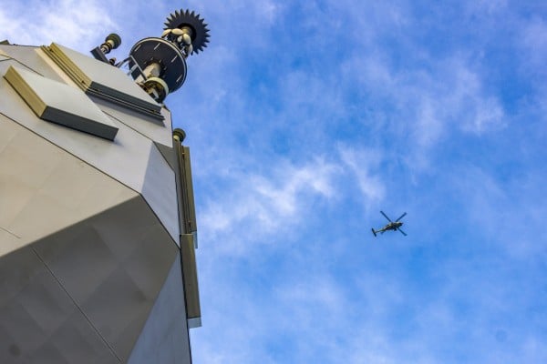 A Royal Australian Navy helicopter flies above the HMAS Toowoomba as it sails in the South China Sea. Photo: Handout A Royal Australian Navy helicopter flies above the HMAS Toowoomba as it sails in the South China Sea. Photo: Handout