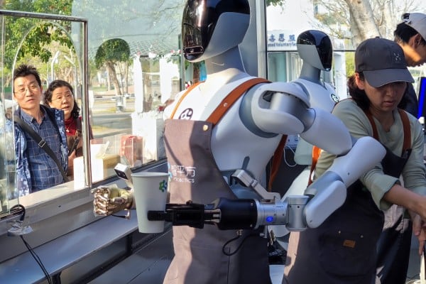 A humanoid robot prepares a drink at a coffee kiosk in Shenzhen on January 28. Photo: Getty Images A humanoid robot prepares a drink at a coffee kiosk in Shenzhen on January 28. Photo: Getty Images