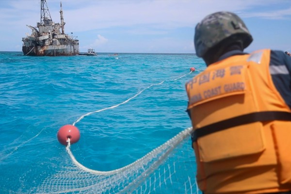 The Chinese coastguard recovers Philippine fishing nets near a disputed area of the South China Sea. Photo: Xinhua