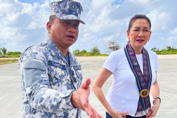 Philippine Coast Guard spokesman Jay Tarriela gestures beside Senator Risa Hontiveros during a visit to Philippine-occupied Thitu island in the disputed South China Sea on February 21. Photo: Reuters