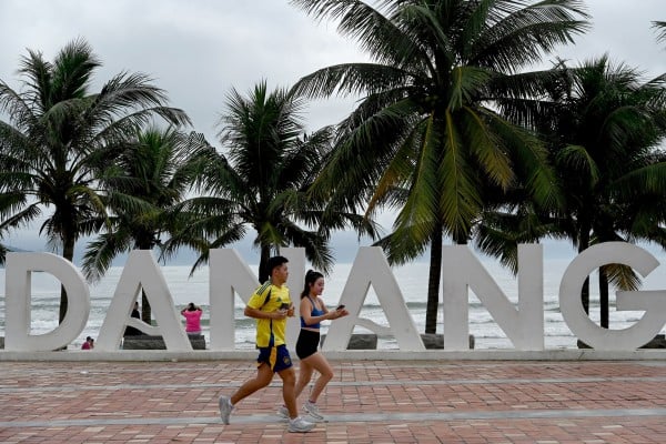 A couple runs along the seafront next to the beach in Da Nang, central Vietnam, last year. Photo: AFP A couple runs along the seafront next to the beach in Da Nang, central Vietnam, last year. Photo: AFP