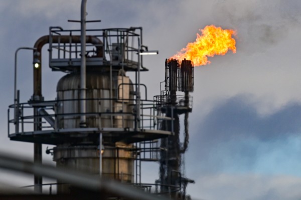 Surplus gas is burnt off in a crude oil processing plant in Germany. The German and Japanese governments will free up some of their national oil reserves. Photo: dpa