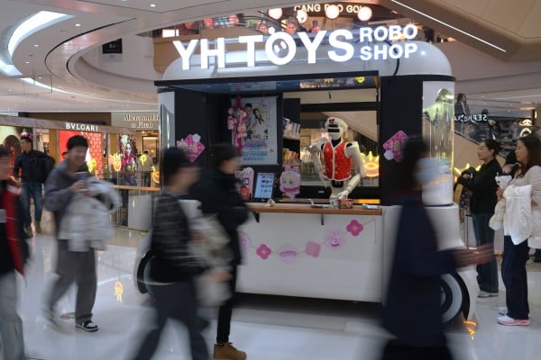 Shoppers walk past a humanoid robot selling toys in a shopping mall in Beijing on February 28. China’s common prosperity agenda, despite its imperfections, reflects an explicit recognition that unchecked inequality is a systemic risk. Photo: AP Shoppers walk past a humanoid robot selling toys in a shopping mall in Beijing on February 28. China’s common prosperity agenda, despite its imperfections, reflects an explicit recognition that unchecked inequality is a systemic risk. Photo: AP