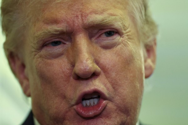 US President Donald Trump speaks to reporters aboard Air Force One on a flight back to Washington on Sunday. Photo: Reuters