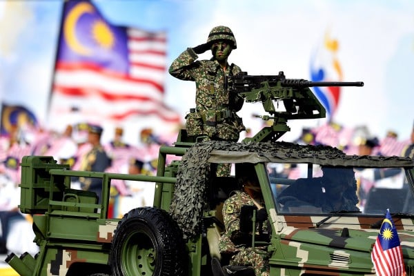 A Malaysian soldier salutes from an armoured vehicle during a National Day parade in Putrajaya, Malaysia, in 2018. Photo: AFP A Malaysian soldier salutes from an armoured vehicle during a National Day parade in Putrajaya, Malaysia, in 2018. Photo: AFP
