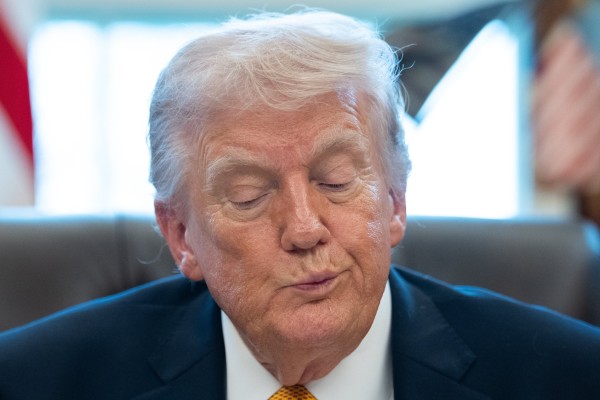 US President Donald Trump signs an executive order at the White House on Monday. Photo: EPA
