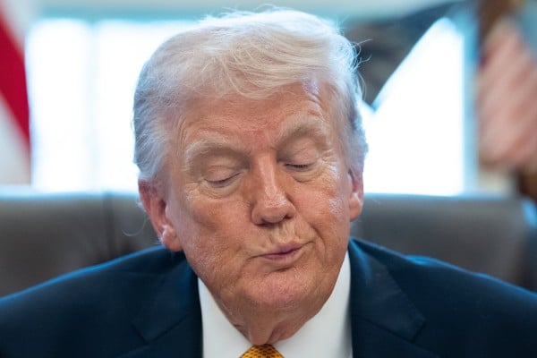 US President Donald Trump signs an executive order at the White House on Monday. Photo: EPA US President Donald Trump signs an executive order at the White House on Monday. Photo: EPA
