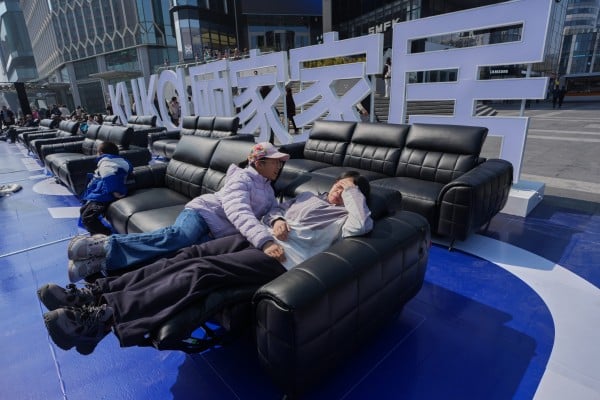 Shoppers test sofas outside a mall in Beijing. Retailers in Beijing and other major Chinese cities are increasingly moving product displays into public areas to boost spending. Photo: AP Shoppers test sofas outside a mall in Beijing. Retailers in Beijing and other major Chinese cities are increasingly moving product displays into public areas to boost spending. Photo: AP