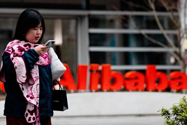A woman walks past the Alibaba logo on its building in Xuhui Binjiang Park, also known as AI Park, in Shanghai, on March 19, 2026. Photo: EPA A woman walks past the Alibaba logo on its building in Xuhui Binjiang Park, also known as AI Park, in Shanghai, on March 19, 2026. Photo: EPA