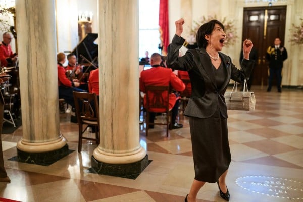 A photograph published by the White House shows Takaichi arriving at an official dinner with her fists raised, handbag over one arm, apparently shouting with delight. Photo: White House A photograph published by the White House shows Takaichi arriving at an official dinner with her fists raised, handbag over one arm, apparently shouting with delight. Photo: White House