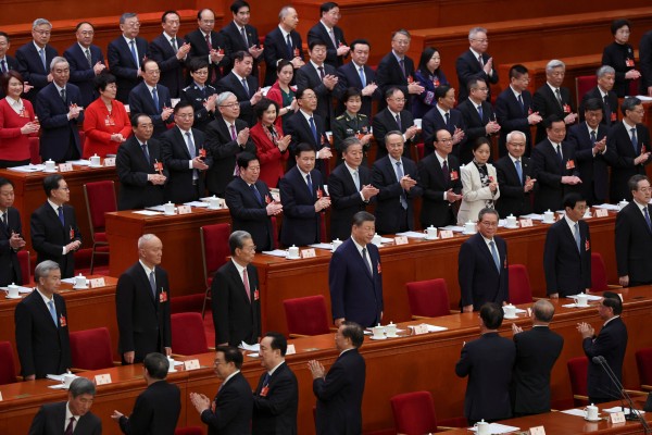 Delegates applaud as Chinese President Xi Jinping and other members of the Politburo arrive for a meeting of the National People’s Congress at the Great Hall of the People in Beijing on March 9. Photo: Reuters