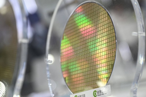A wafer sample on display during the Semicon China semiconductor exhibition in Shanghai. March 25, 2026. Photo: AFP