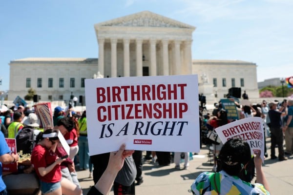 A protester holds a sign in support of birthright citizenship outside the US Supreme Court on Wednesday. Photo: AFP A protester holds a sign in support of birthright citizenship outside the US Supreme Court on Wednesday. Photo: AFP