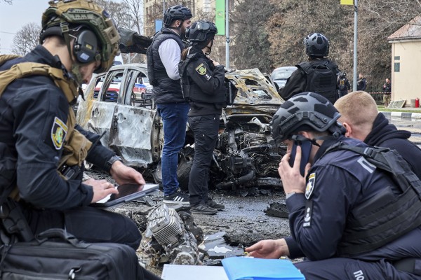 Ukrainian experts work at the site of a Russian drone strike on a residential area in Kharkiv, Ukraine, on Friday. Photo: EPA