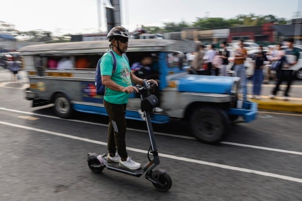 A person on an electric scooter passes a jeepney at a transport terminal in Quezon City on March 19. The Philippines is grappling with a national energy emergency triggered by the war in Iran. Photo: EPA A person on an electric scooter passes a jeepney at a transport terminal in Quezon City on March 19. The Philippines is grappling with a national energy emergency triggered by the war in Iran. Photo: EPA