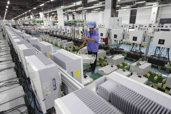 An employee works on the production line at FoxESS, a global leader in the development of inverter and energy storage solutions. Photo: Getty Images