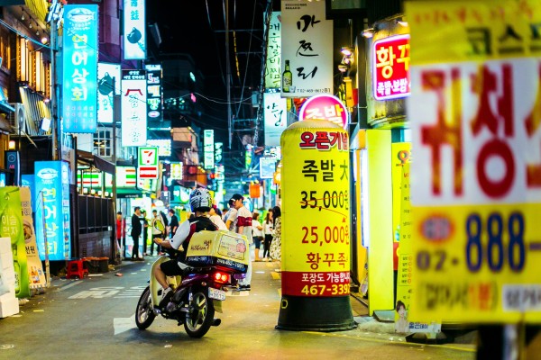 A delivery man makes his way on motorbike through Seoul’s busy Hongdae neighbourhood. Photo: Shutterstock
