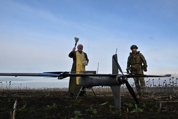 An Orthodox chaplain sprinkles holy water on a Gara combat drone in Zaporizhzhia region, Ukraine, on Wednesday. Photo: Reuters An Orthodox chaplain sprinkles holy water on a Gara combat drone in Zaporizhzhia region, Ukraine, on Wednesday. Photo: Reuters
