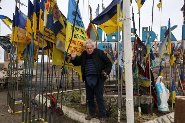 Britain’s former Prime Minister Boris Johnson stands surrounded by Ukrainian national flags and flags of military units as he visits the frontline town of Orikhiv in the Zaporizhzhia region of Ukraine. Photo: via AP Britain’s former Prime Minister Boris Johnson stands surrounded by Ukrainian national flags and flags of military units as he visits the frontline town of Orikhiv in the Zaporizhzhia region of Ukraine. Photo: via AP
