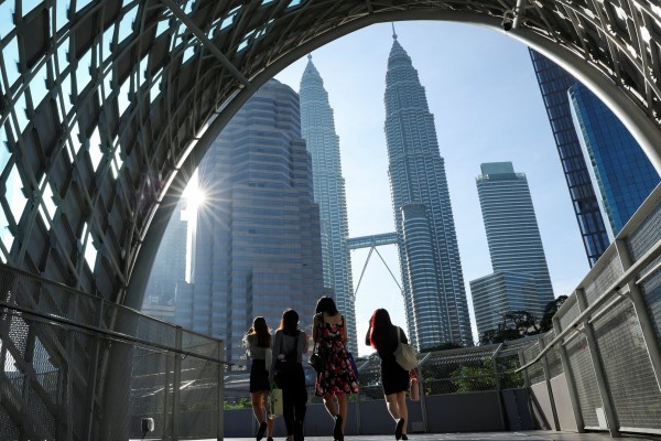 People walk to their workplace during the morning rush at Kuala Lumpur city centre, Malaysia. Photo: Reuters