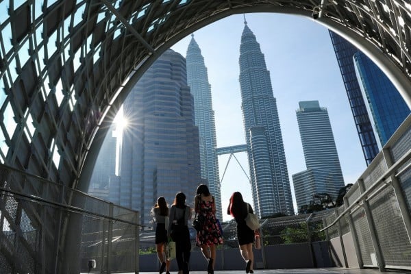 People walk to their workplace during the morning rush at Kuala Lumpur city centre, Malaysia. Photo: Reuters People walk to their workplace during the morning rush at Kuala Lumpur city centre, Malaysia. Photo: Reuters