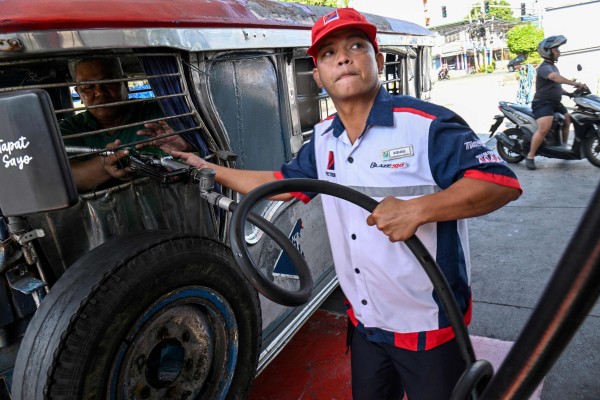 A jeepney driver refuels his vehicle with diesel in Manila last month. Photo: AFP