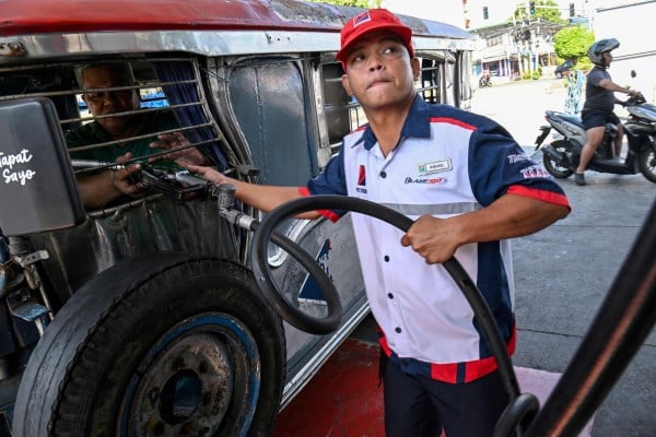 A jeepney driver refuels his vehicle with diesel in Manila last month. Photo: AFP A jeepney driver refuels his vehicle with diesel in Manila last month. Photo: AFP