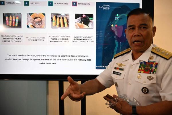 Philippine Navy spokesman Rear Admiral Roy Vincent Trinidad speaks next to a slide presentation of seized yellow bottles suspected to contain cyanide in waters of Second Thomas Shoal in the disputed South China Sea, during a press conference in Manila on Monday. Photo: AFP Philippine Navy spokesman Rear Admiral Roy Vincent Trinidad speaks next to a slide presentation of seized yellow bottles suspected to contain cyanide in waters of Second Thomas Shoal in the disputed South China Sea, during a press conference in Manila on Monday. Photo: AFP