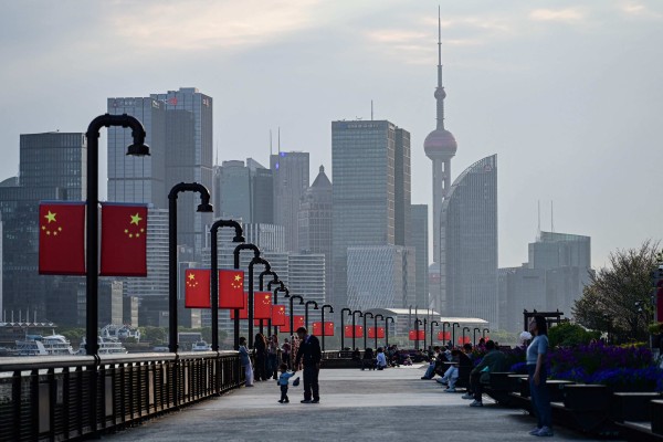 People walk beside the Huangpu River in Shanghai on April 9. Photo: AFP
