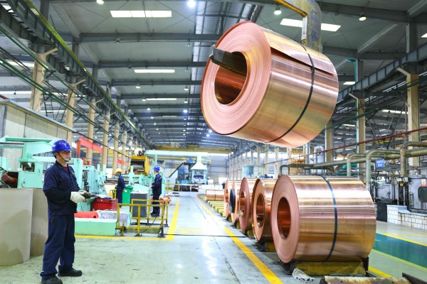 A coil of copper is moved at an electrical materials factory in Dongyang, Zhejiang province, on Tuesday. Photo: AFP