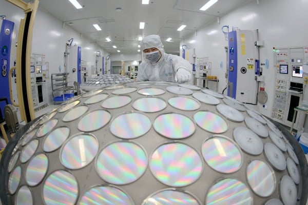A worker produces LED chips on a production line in China’s Jiangsu province. Photo: Getty Images A worker produces LED chips on a production line in China’s Jiangsu province. Photo: Getty Images