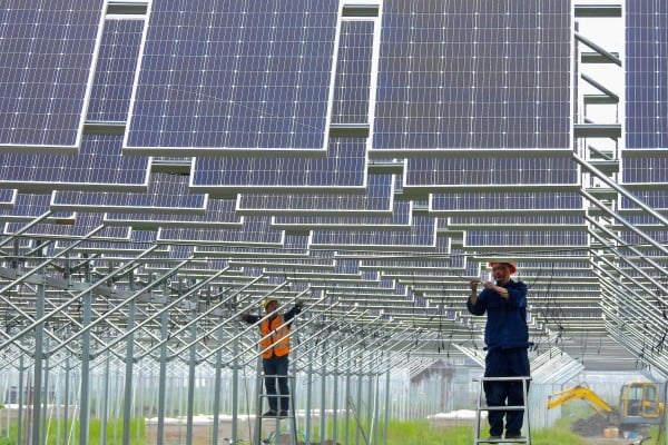 Workers install solar panels in China’s eastern Jiangsu province. Photo: Reuters Workers install solar panels in China’s eastern Jiangsu province. Photo: Reuters