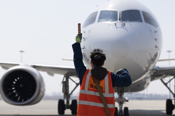 A ground crew member directs a C919 jetliner operated by China Eastern Airlines at Harbin Taiping International Airport in Harbin, northeast China’s Heilongjiang province, on April 15. Photo: Xinhua A ground crew member directs a C919 jetliner operated by China Eastern Airlines at Harbin Taiping International Airport in Harbin, northeast China’s Heilongjiang province, on April 15. Photo: Xinhua