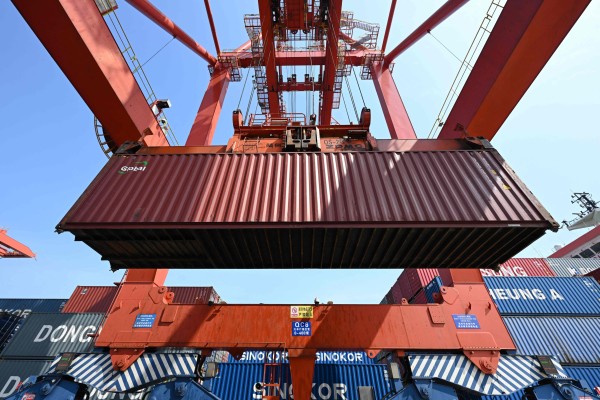 A crane loads cargo onto a ship at a port in Zhangjiagang, in China’s eastern Jiangsu province. Photo: AFP