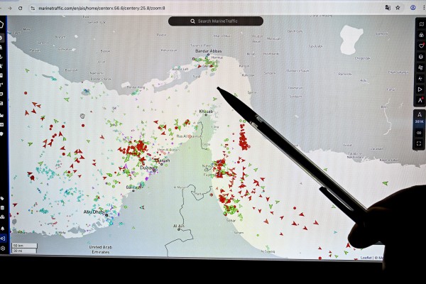 A person points at a page on the Marine Traffic website that shows commercial boats traffic on the edge of the Strait of Hormuz near the Iranian coast, in Paris on March 4. Photo: TNS