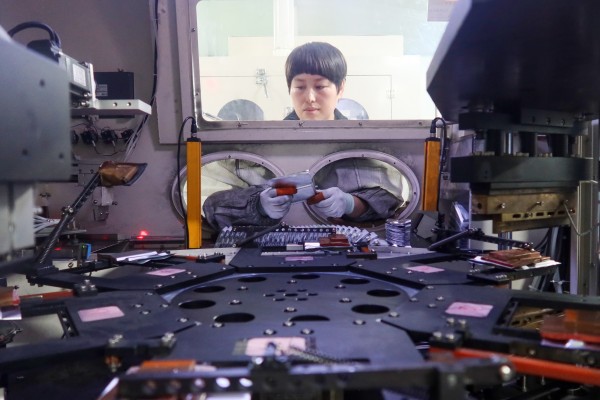 A worker at Henan Pude New Energy Technology assembling lithium-ion batteries in Sanmenxia city, Henan province, China, on March 12. Photo: Getty Images