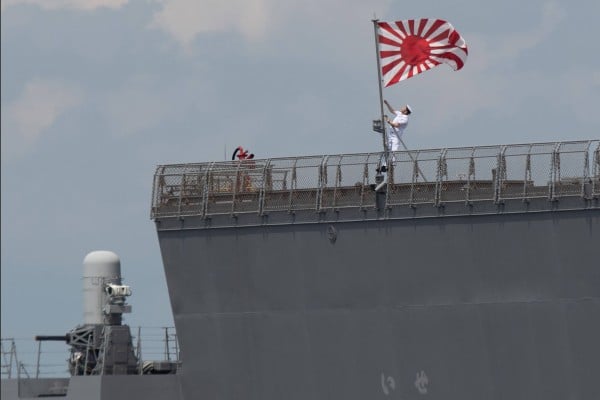 A sailor raises the Japan Maritime Self-Defence Force ensign on board the JS Ise helicopter destroyer as it docks in Manila last year. Photo: AFP A sailor raises the Japan Maritime Self-Defence Force ensign on board the JS Ise helicopter destroyer as it docks in Manila last year. Photo: AFP