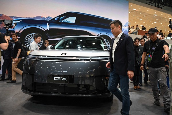 He Xiaopeng, CEO of Chinese electric vehicle maker Xpeng, walks past the new SUV GX six-seater on the opening day of Auto China 2026 in Beijing. Photo: AFP