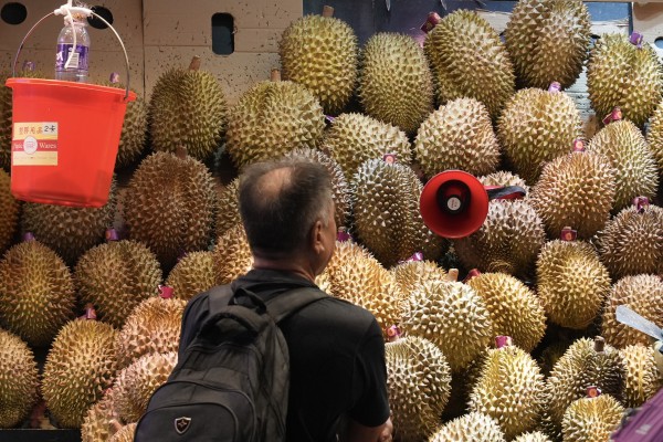 A shopper browses a mound of durians at a market in Hong Kong. Photo: Eugene Lee