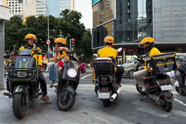 Delivery riders sit on scooters while waiting for orders at an intersection on March 24 in Shenzhen. Photo: Getty Images
Delivery riders sit on scooters while waiting for orders at an intersection on March 24 in Shenzhen. Photo: Getty Images